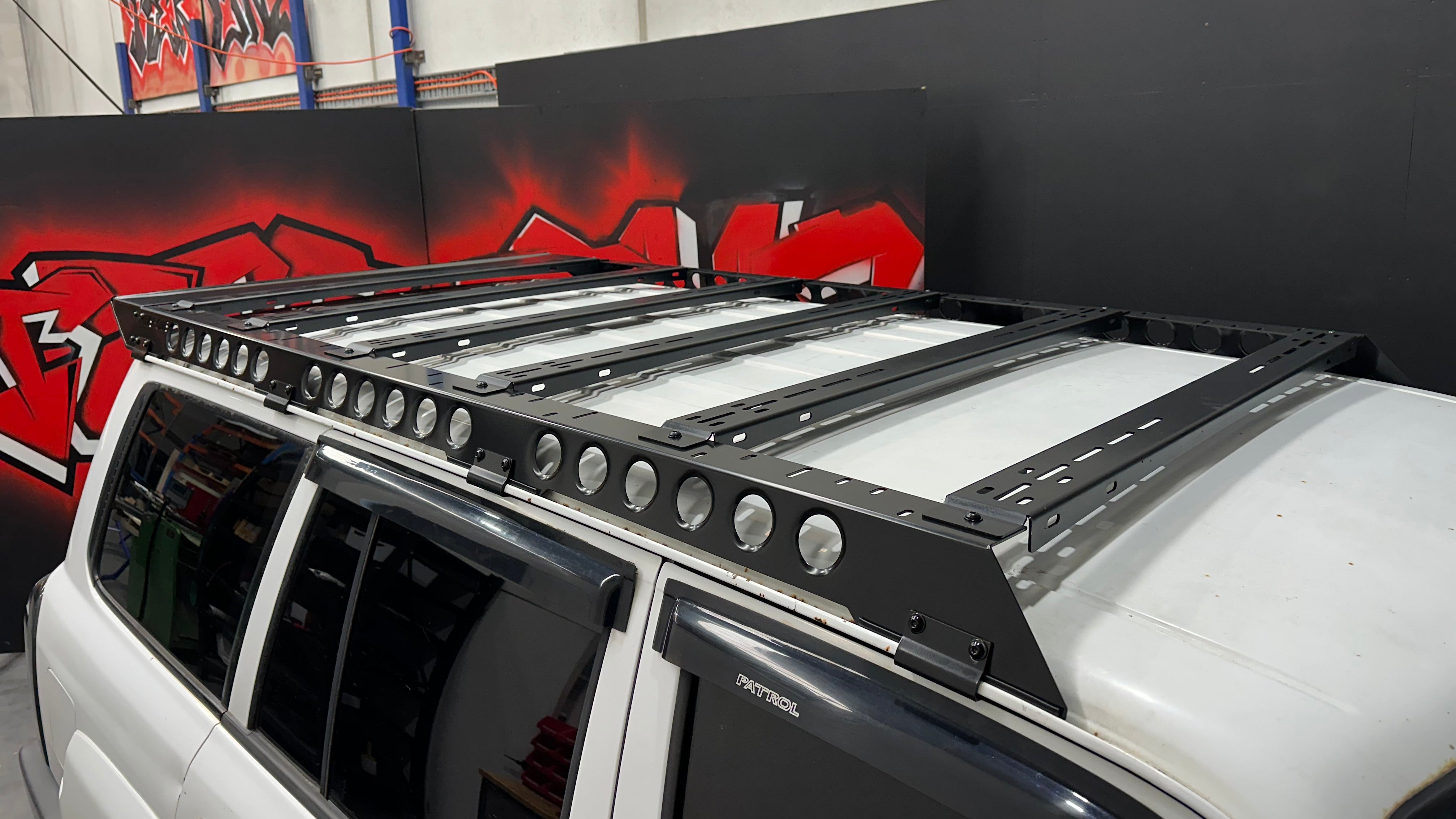 Tier One Metalworks roof rack installed on a white Nissan Patrol 4WD