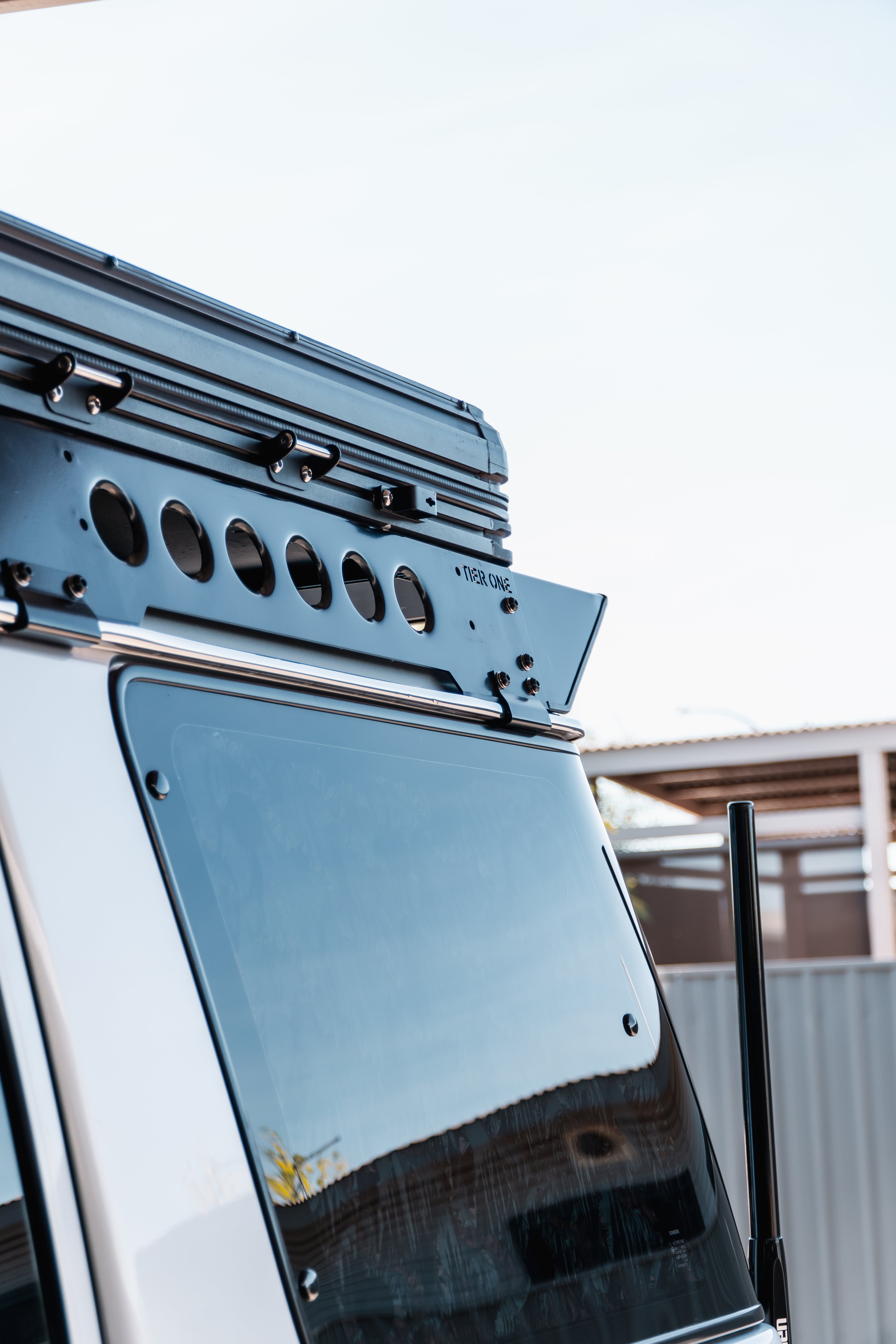This is an image of a silver 4x4 with Tier One Metalworks black roof racks and rails installed.