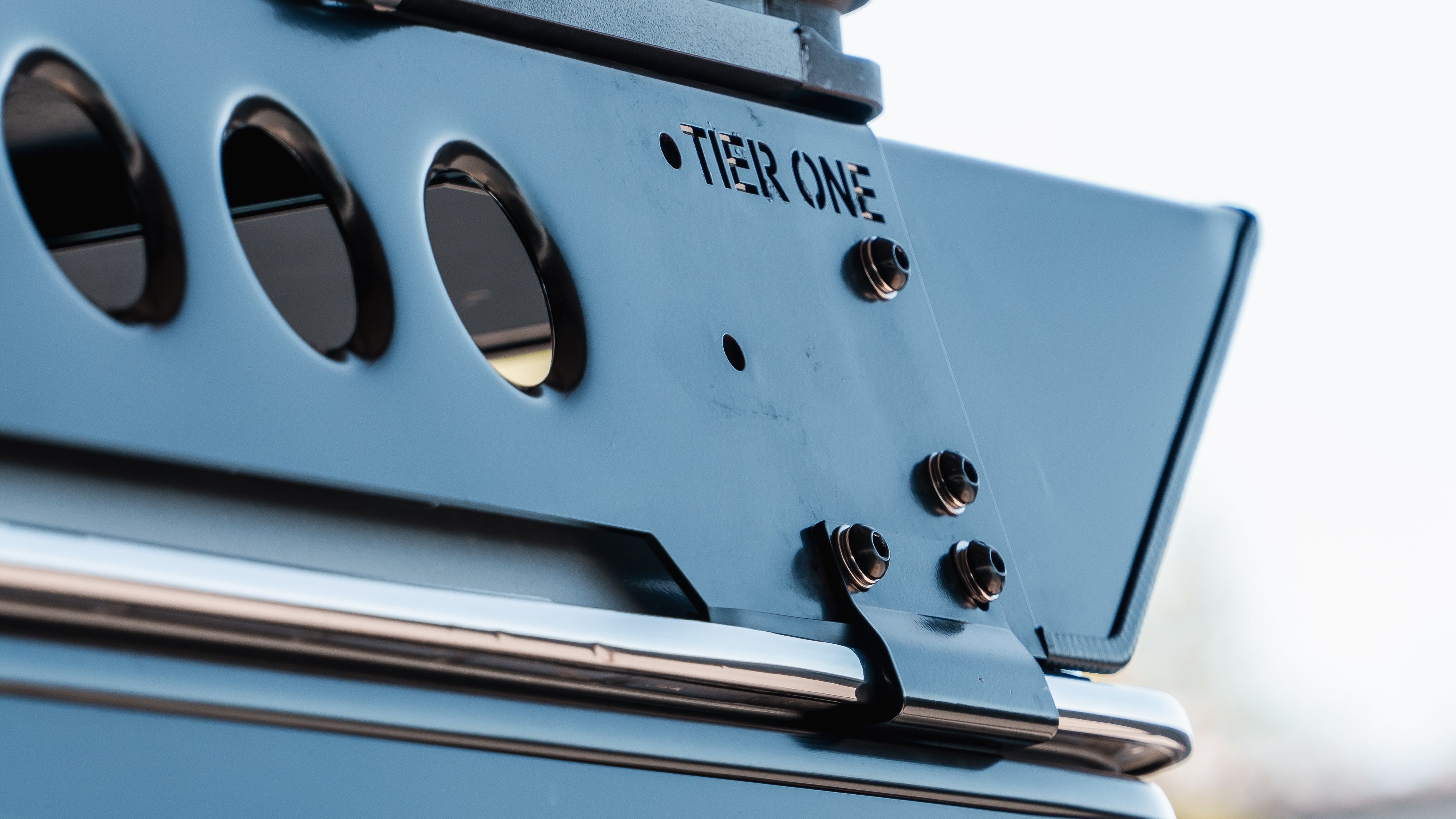 This is an image of a Tier One Metalworks Roof Rack mounted on a vehicle with a metal frame and mounting bolts