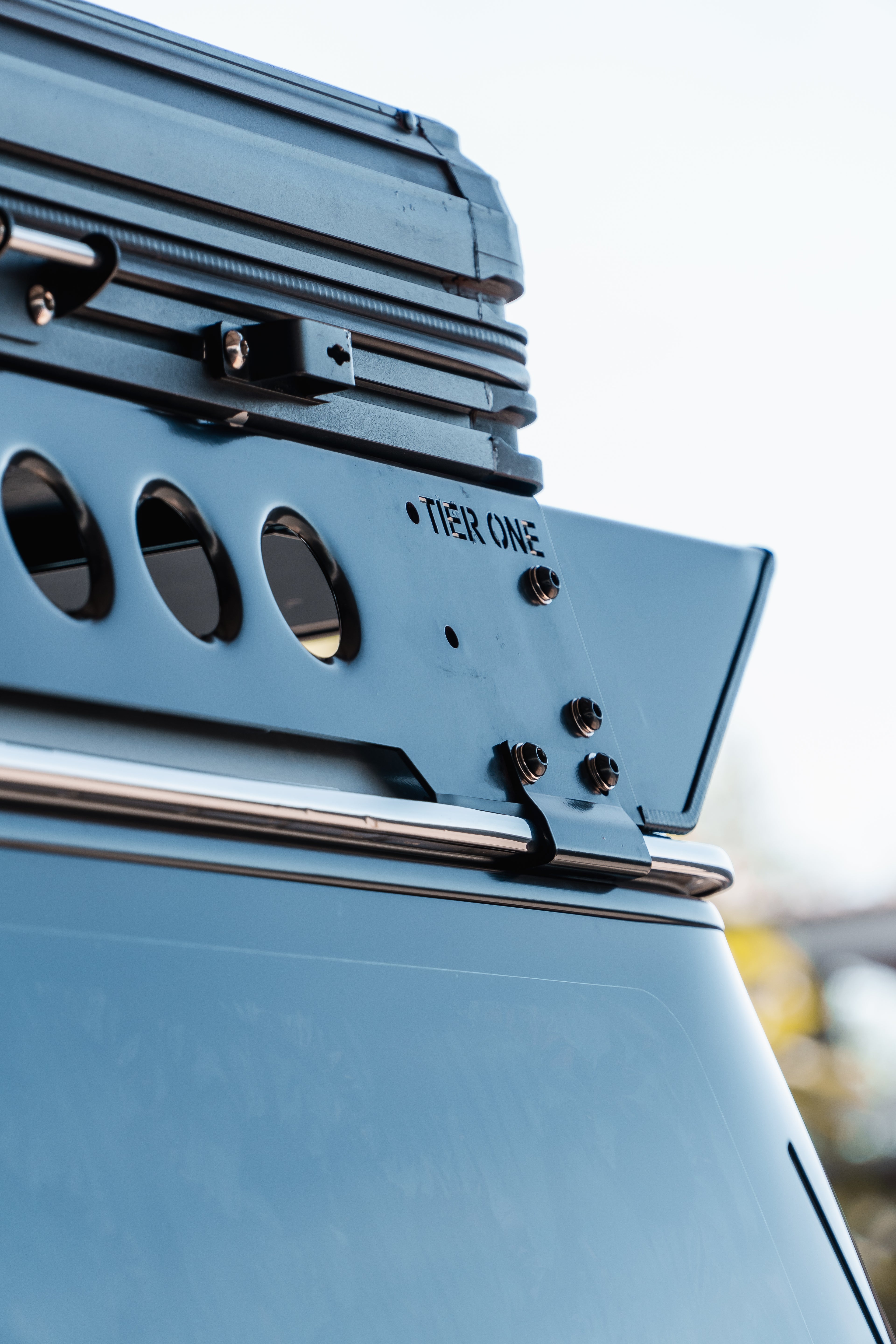 This is an image of a Tier One Metalworks Roof Rack mounted on a vehicle with a metal frame and mounting bolts