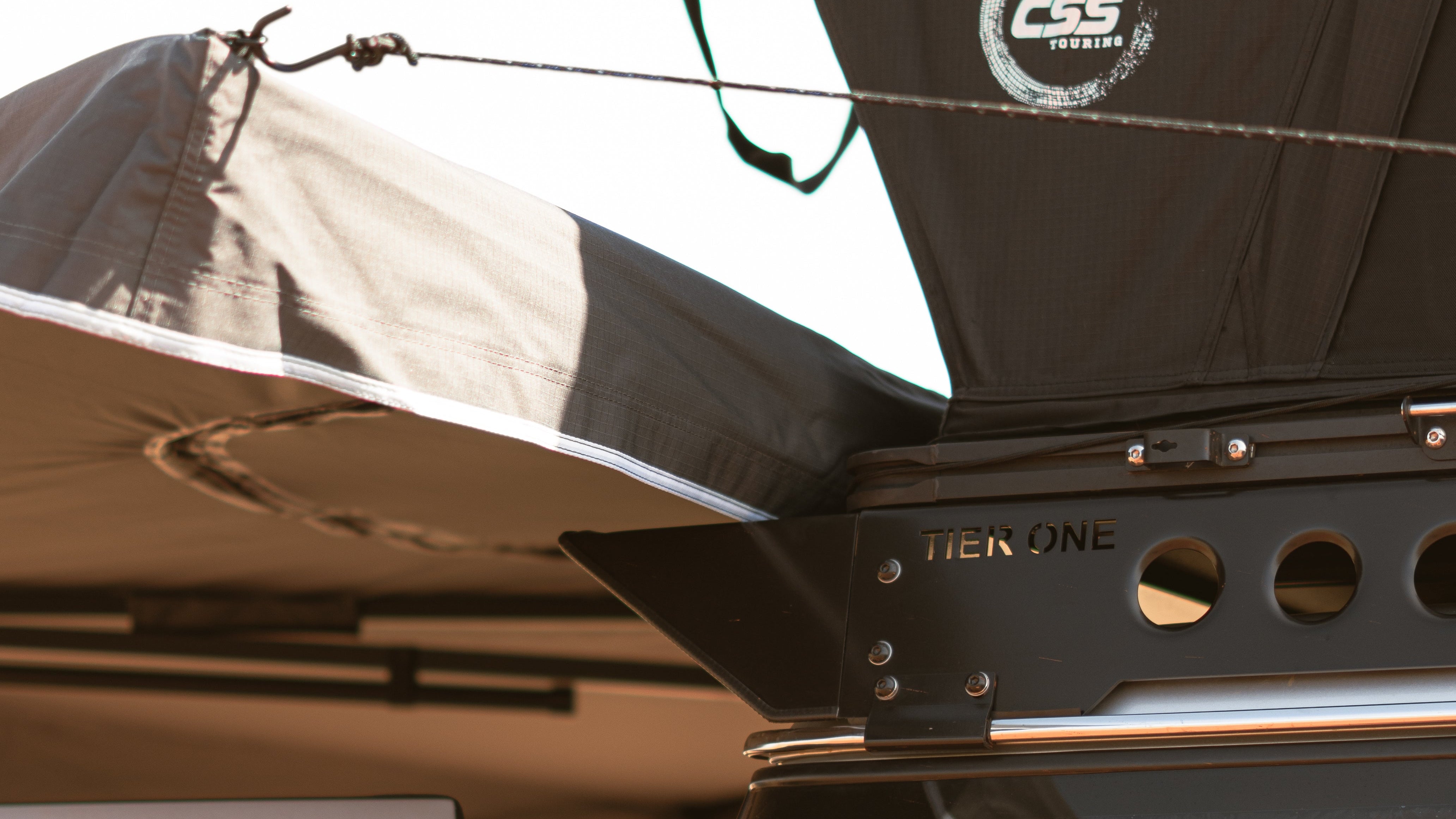 This is an image of a Tier One Metalworks roof rack with CSS Touring rooftop tent on a 4x4 vehicle.
