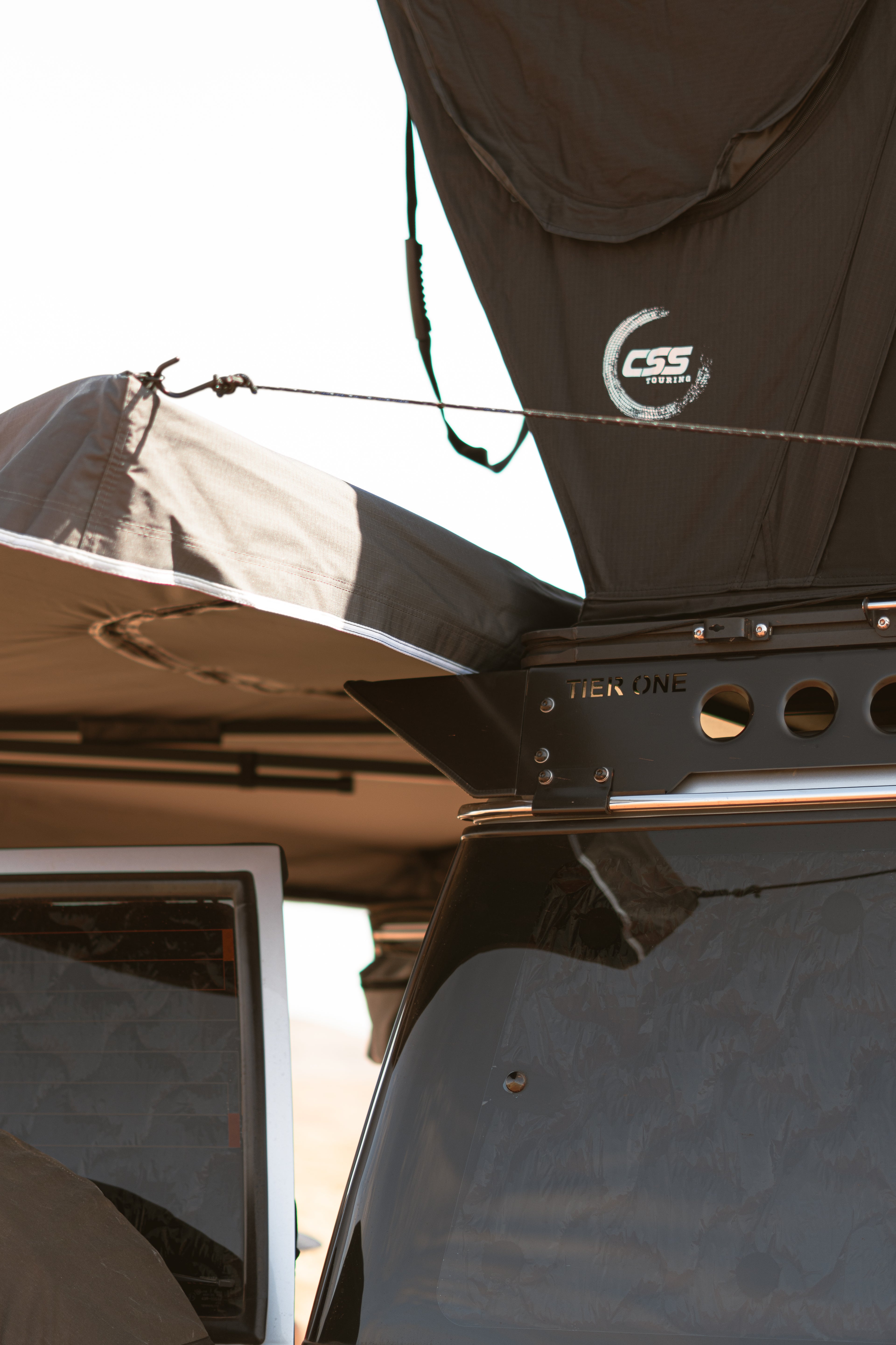 This is an image of a Tier One Metalworks roof rack with CSS Touring rooftop tent on a 4x4 vehicle.
