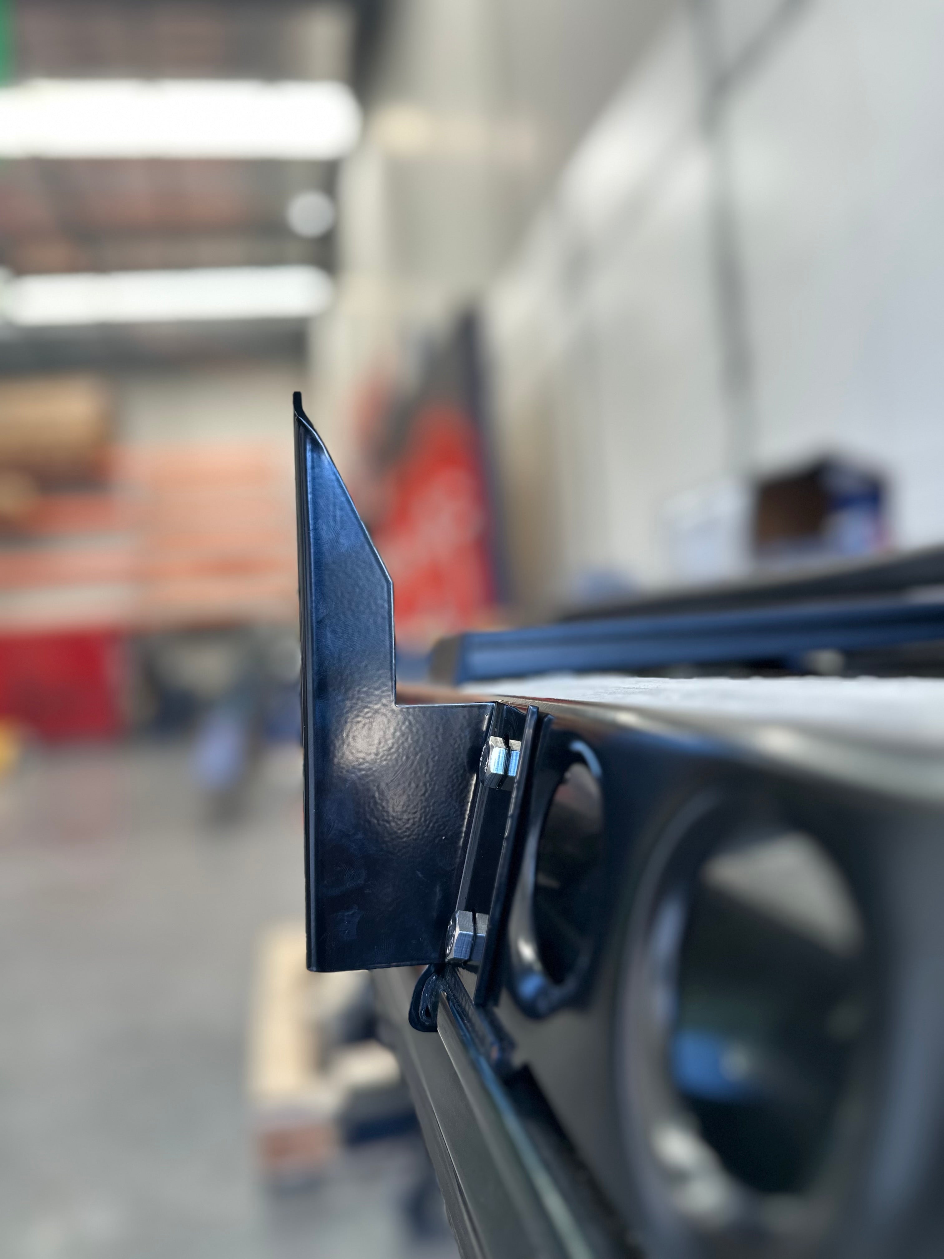 This is an image of a close-up black metal bracket attachment on a custom 4WD roof rack by Tier One Metalworks in an Australian workshop