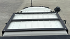 This is an image of a black Tier One Metalworks Roof Rack installed on a white Toyota Landcruiser 79 Series single cab roof